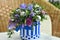 Bouquet of Christmas tree with Christmas decorations and live lilac flowers in a striped basket