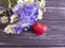 bouquet of cornflowers, chamomile holiday heart, on a wooden background