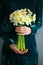 Bouquet daffodil in the hands of women