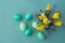 Bouquet of daffodils, tulips and Muscari.Easter. Easter eggs are blue and turquoise.