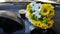 Bouquet. Daisies and a glass of coffee on the dashboard of my car