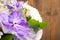 Bouquet of daisy and purple orchid on wooden background