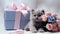 bouquet of delicate pink roses with cute kitten holding a gift, silk blue ribbons,