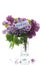 bouquet of different blooming spring lilacs in a vase on white background