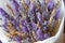 Bouquet of dried flowers in the hands of a florist girl lavender cereal on a gray background