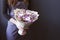 Bouquet of dried flowers in the hands of a florist girl lavender cereal on a gray background