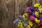 Bouquet of dried flowers statice lies on a wooden table