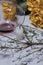 A bouquet of dried yellow roses and candle stubs. An overturned glass with sour wine and a spruce branch with fallen heads