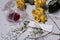 A bouquet of dried yellow roses and candle stubs. An overturned glass with sour wine and a spruce branch with fallen heads. Nearby