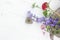 bouquet of dry flowers and potpourri in a Wood plate on a white table