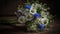 bouquet features colorful wildflowers including wild roses with the vibrant blue of cornflowers