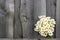 Bouquet field chamomile flowers in fence on old wooden background. Concept rustic romantic surprise. Copy space Minimal style,