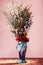 Bouquet of field dried flowers in vintage blue vase