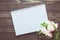 Bouquet of flower and empty diary notebook on rustic wooden table with copy space, mockup template with flower and note