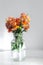 Bouquet flower in glass vase with indoor grey wall background
