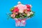 Bouquet of flowers on a blue background. Congratulations to the women. Flowers are loved. Place for writing. Flat lay