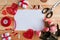 Bouquet of flowers, handmade red thread hearts and white mockup blank on wooden table, cope space.