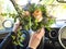 Bouquet of flowers in the hands of the driver