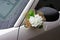 Bouquet of flowers on the mirror wedding car