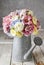 Bouquet of flowers in silver watering can