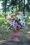 Bouquet of flowers in stone vase in an exterior of city park