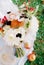 Bouquet of flowers on a white curtain on green grass. Top view