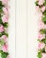 Bouquet frame of beautiful pink roses on white wooden background