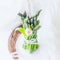 Bouquet of fresh asparagus and pink tulip on a light background