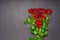 Bouquet of fresh red rose flowers on black background. Floral composition, mourning card for event, mock up. Mourning, condolence