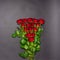 Bouquet of fresh red rose flowers on black background. Floral composition, mourning card for event, mock up. Mourning, condolence