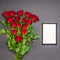 Bouquet of fresh red rose flowers and empty photoframe on black background. Floral composition, mourning card for event, mock up.