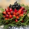 A bouquet of fresh rose hip, fir branches, autumn decor