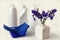 A bouquet of fresh Siberian irises with napkins on the background of detergents in white bottles, side view-the concept of