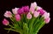 Bouquet of fresh tulips flowers on a table in empty house. Fresh summer pink flowers symbolising hope, love and growth