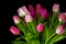 Bouquet of fresh tulips flowers on a table in empty house. Fresh summer pink flowers symbolising hope, love and growth