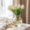 Bouquet of fresh white tulips flowers in a vase in bedroom by a window. Beautiful tulips in a clear glass vase with water in the