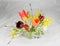 Bouquet of freshly cut spring flowers in glass vase against cri