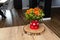 A bouquet of gerbera and chamomile wildflowers in a pot on a table in the living room.