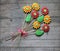 Bouquet of gingerbread flowers on rustic wooden background. Gift