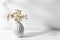 Bouquet of gypsophila in white corrugated vase