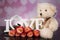 A bouquet of haber roses and a teddy bear mascot. Valentine`s Day