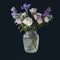 Bouquet of hackelia velutina, purple and white roses, small tea roses, matthiola incana in glass vase isolated on black background