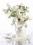 Bouquet of a jasmin and tea cup on a white background