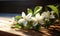 Bouquet of jasmine flowers on wooden table, closeup