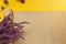 A bouquet of lavender flowers and craft paper for floristry on a bright yellow background. Baner for the florist. View from above