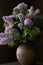 Bouquet of lilac flowers in old round vase