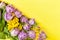 Bouquet of lilac tulips and yellow mimosas on yellow background, copy space, top view, closeup. March 8, February 14, birthday,