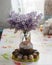 Bouquet of lilacs near Easter cakes and colored eggs.