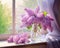 bouquet of lilacs in a vase on the window.