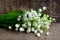 Bouquet of lilies of the valley on old wooden background.Lily of the valley spring flowers.Concept for MotherÂ´s day or Birthday.